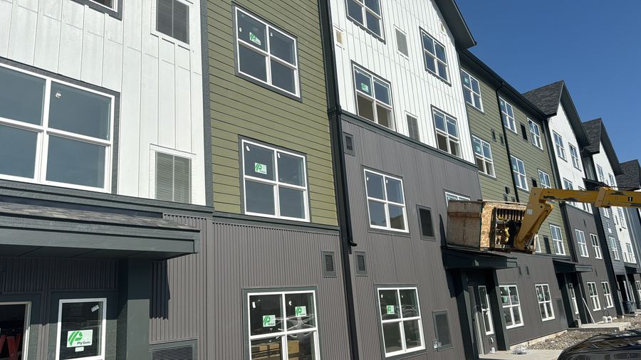 Townhomes with green, white and grey siding