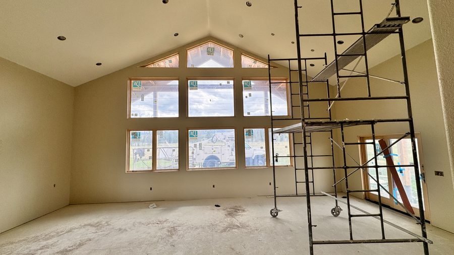 Scaffolding set up against the gable windows of a great room